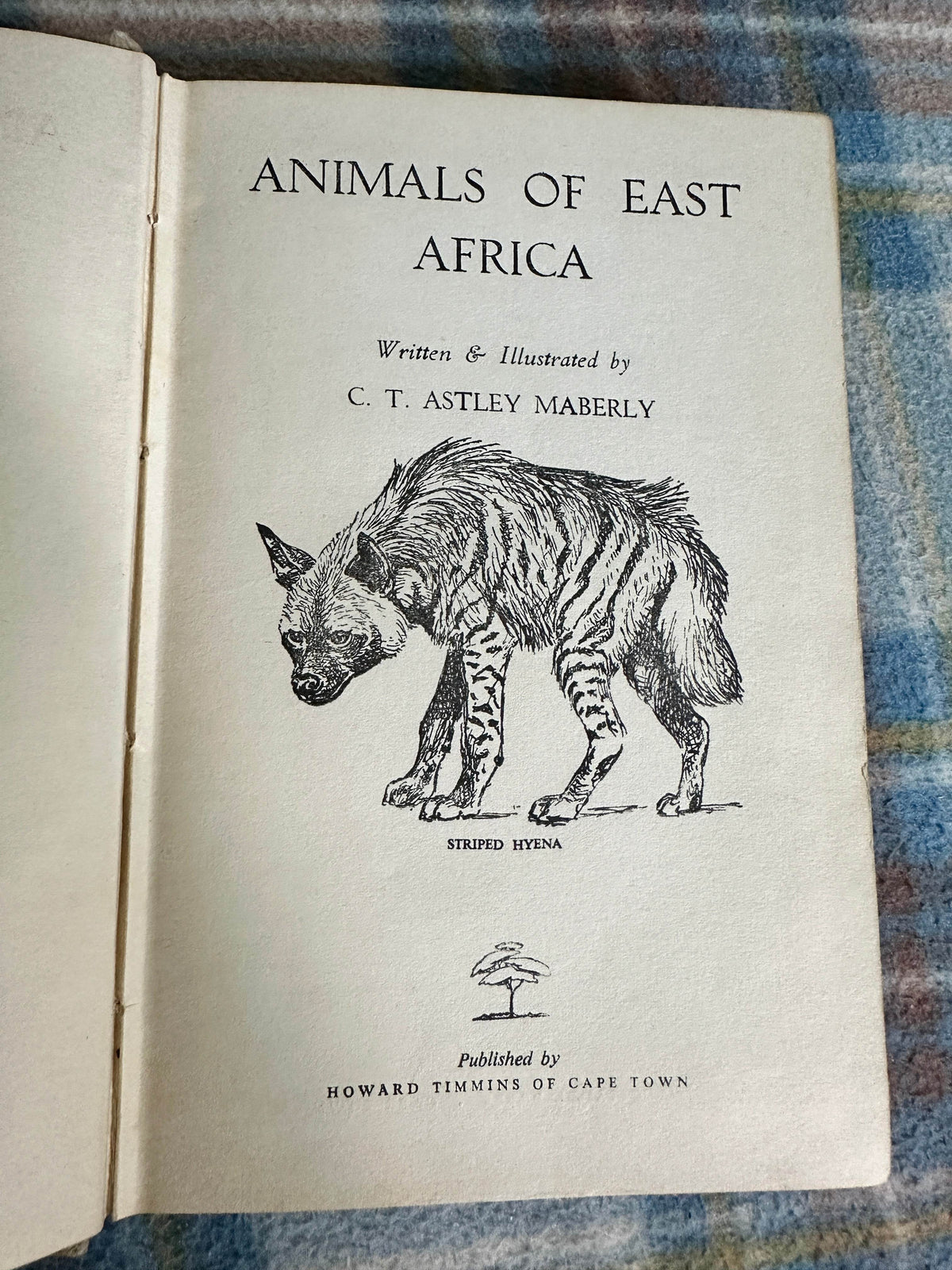1960 Animals of East Africa book cover featuring a striped hyena illustration by C. T. Astley Maberly
