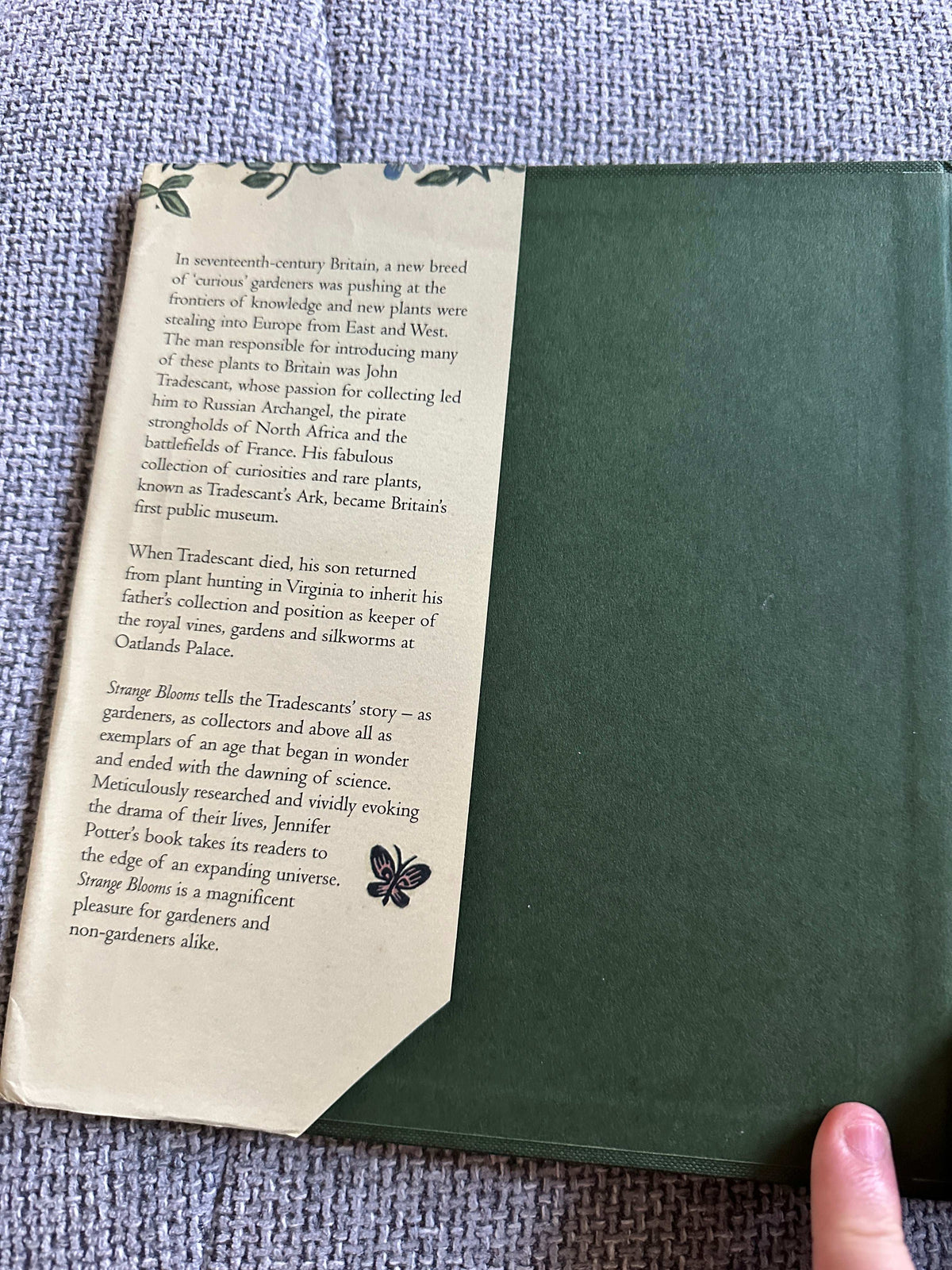 Strange Blooms first edition for sale, showcasing the book's back cover with a green design and detailed description.