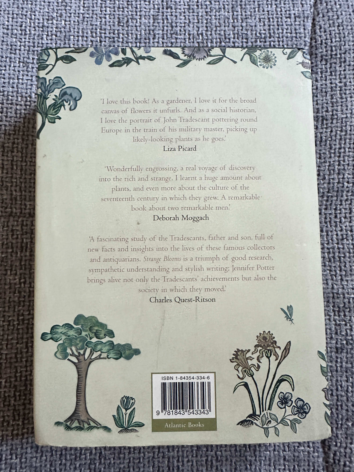 Back cover of Strange Blooms first edition for sale with floral illustrations and quotes from famous gardeners