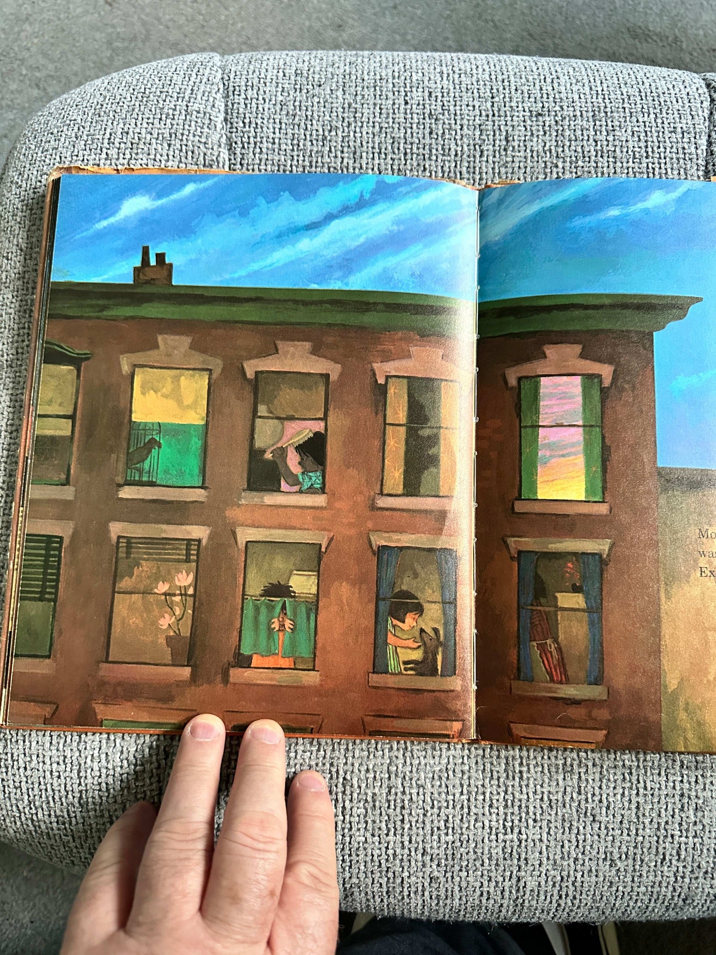 Opened first edition of Dreams Ezra Jack Keats with colorful illustrations of children in windows