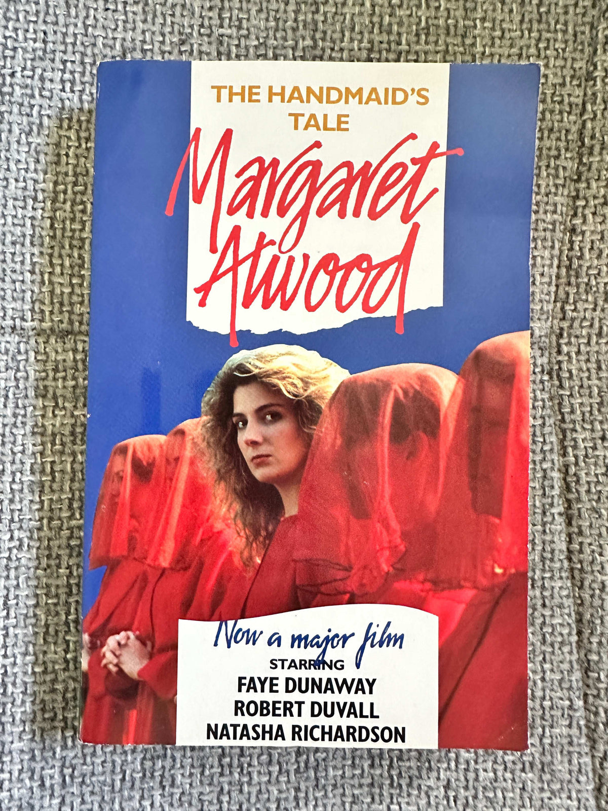 Margaret Atwood first edition 1990 of The Handmaid's Tale fiction book with blue cover and red cloaked figures