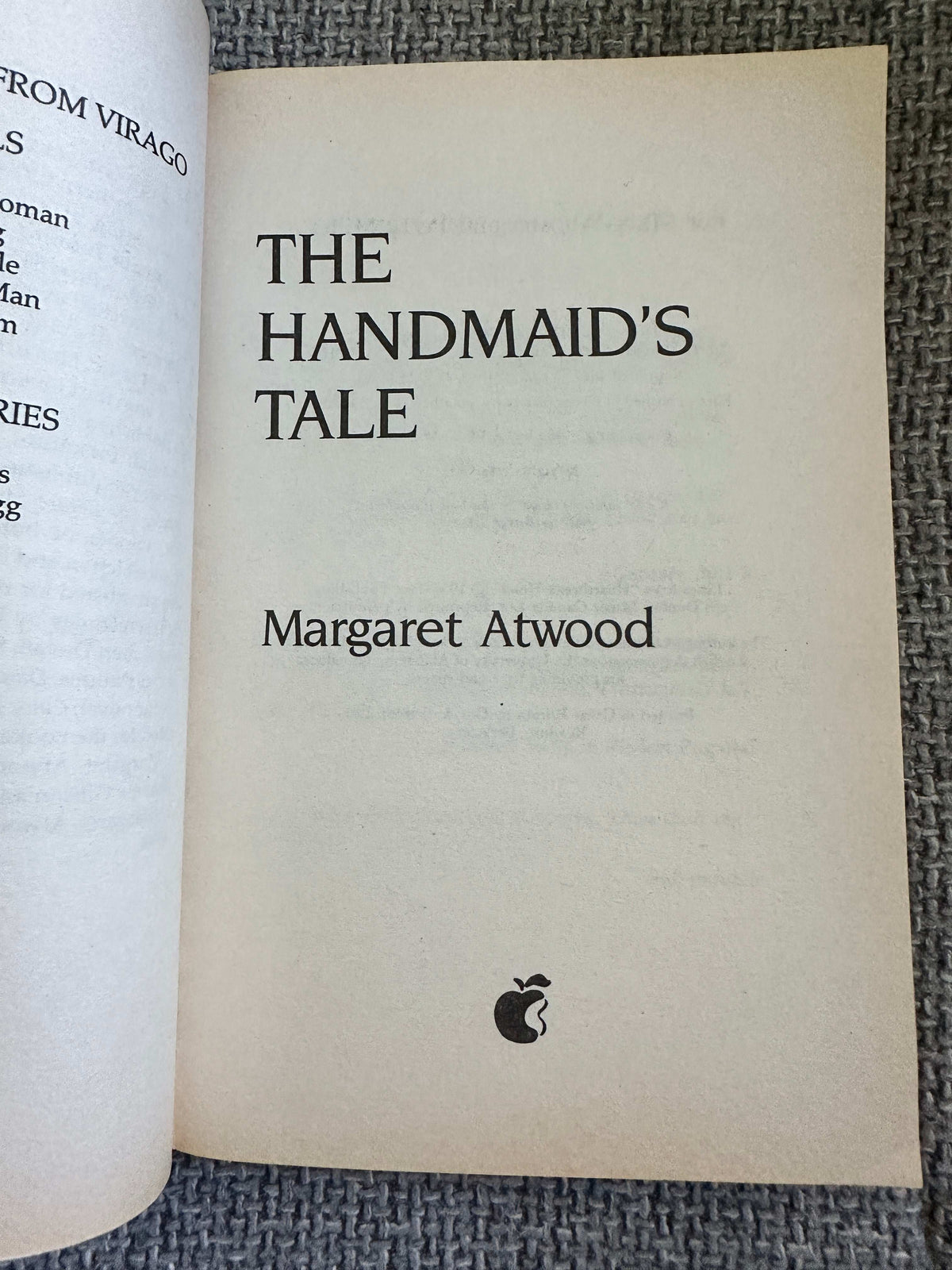 Margaret Atwood first edition 1990 of The Handmaids Tale open book page with title and author