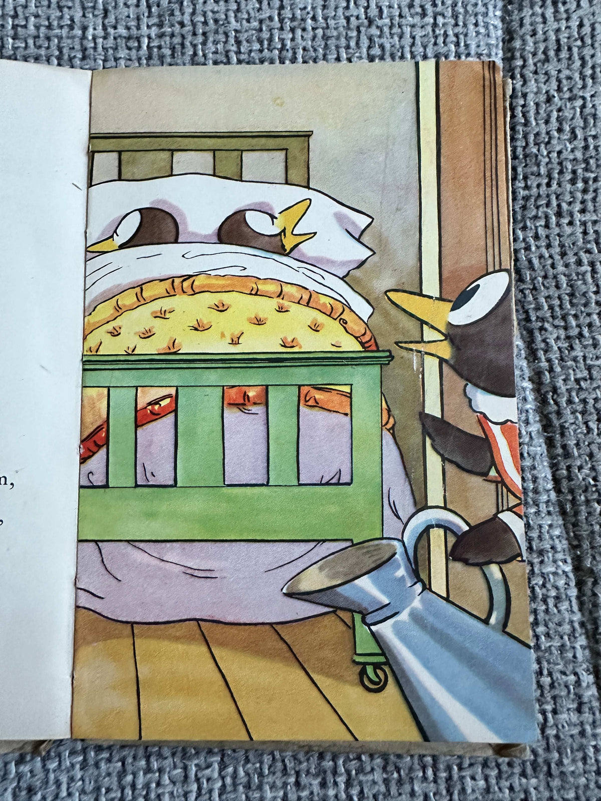 Colorful illustration from The First Day of the Holidays vintage children's book featuring playful penguins in a cozy bedroom