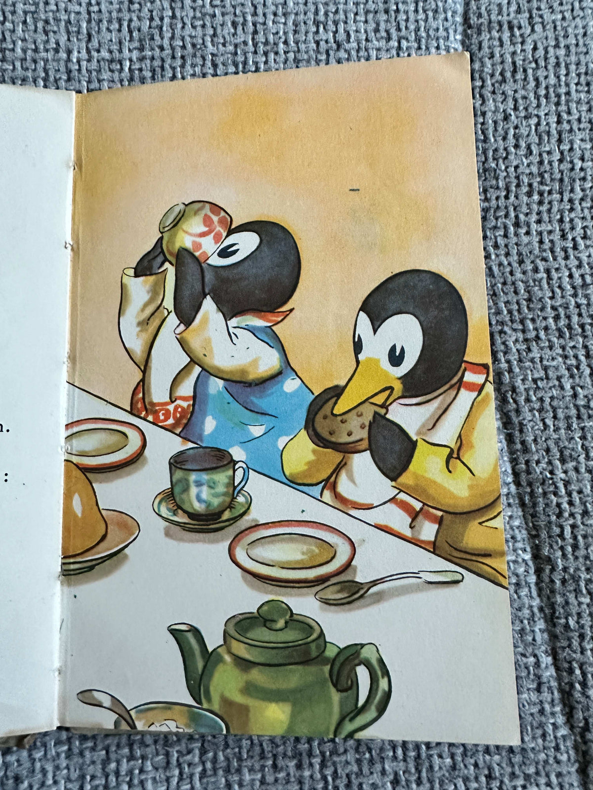 Illustration from The First Day of the Holidays vintage children's book featuring penguins at a tea party