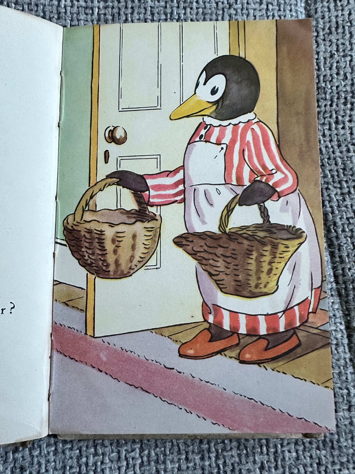 The First Day of the Holidays vintage children's book featuring a penguin in striped attire holding wicker baskets