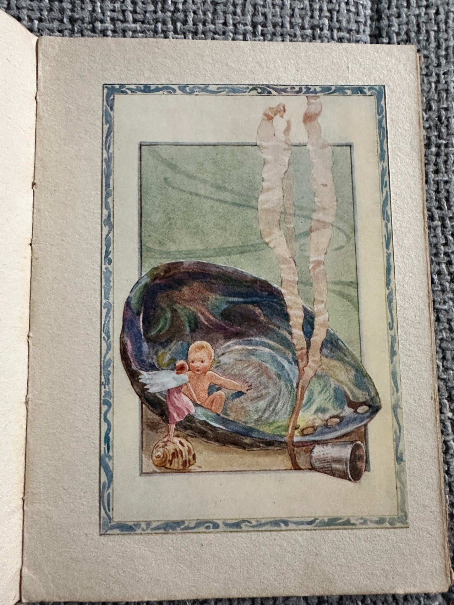 The Sea-Shore Fairies first edition book illustration of a fairy in a shell with seaside elements