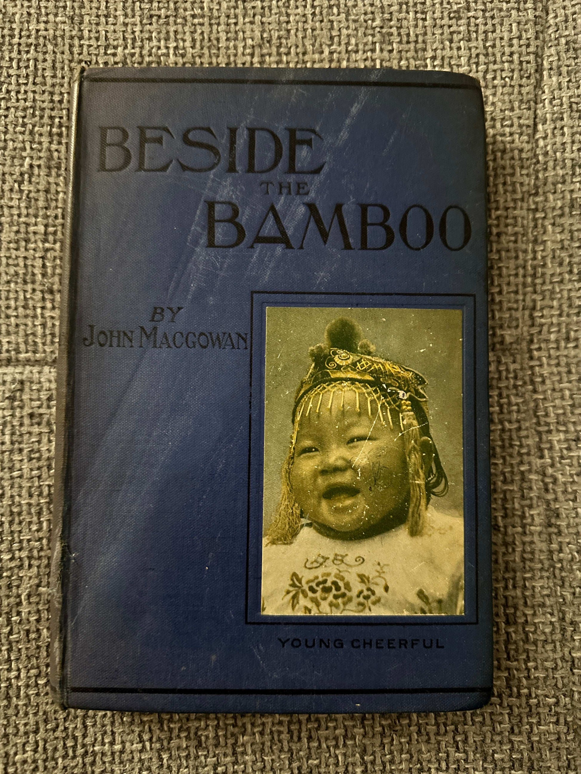 1914 Beside the Bamboo John MacGowan book cover featuring a young child in traditional attire