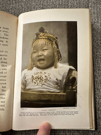 1914 Beside the Bamboo by John MacGowan with a smiling child in traditional dress on the page