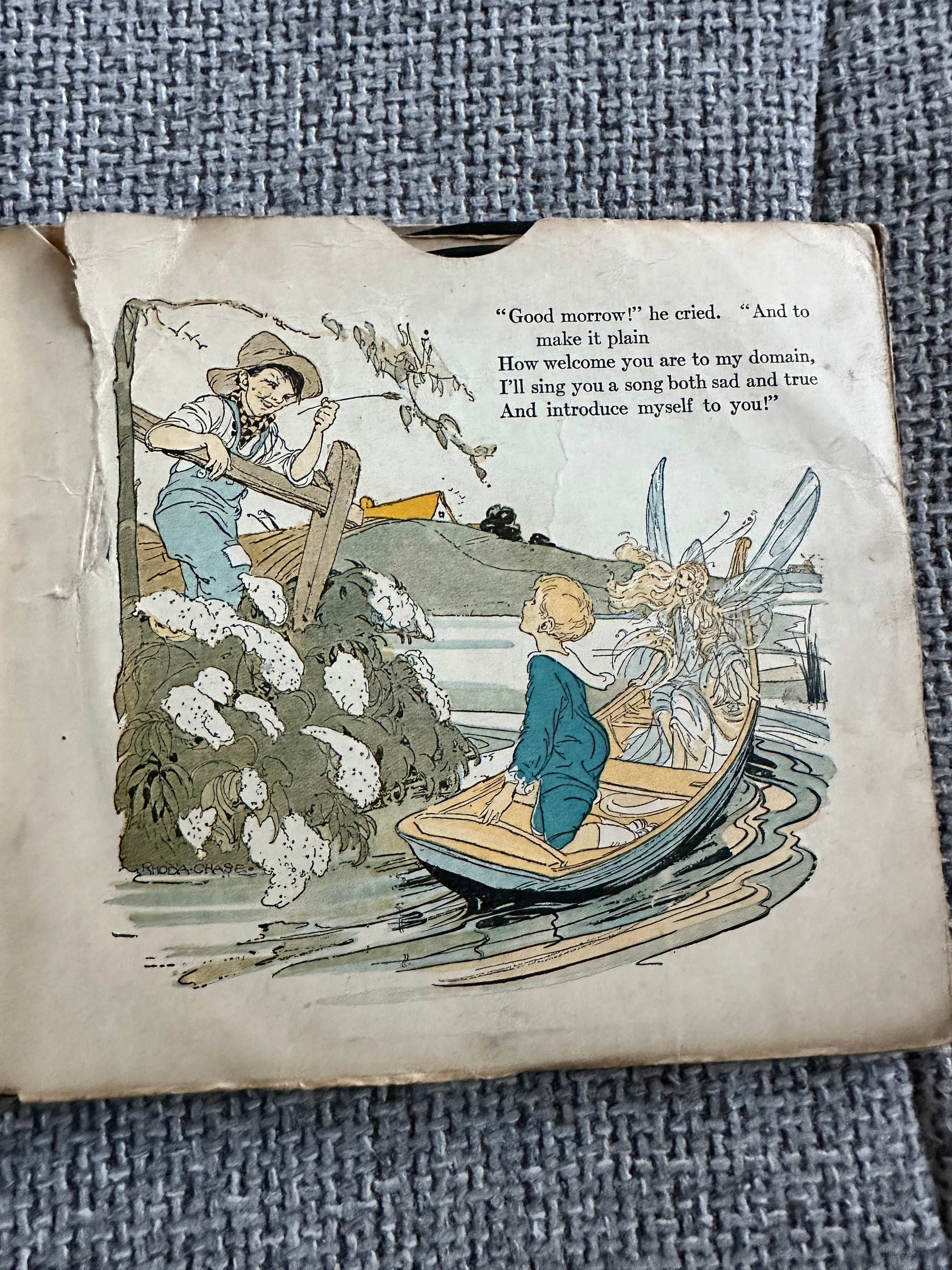 Illustration from the 1917 Happy Go Lucky Bubble Book for sale depicting a boy in a boat with a fairy