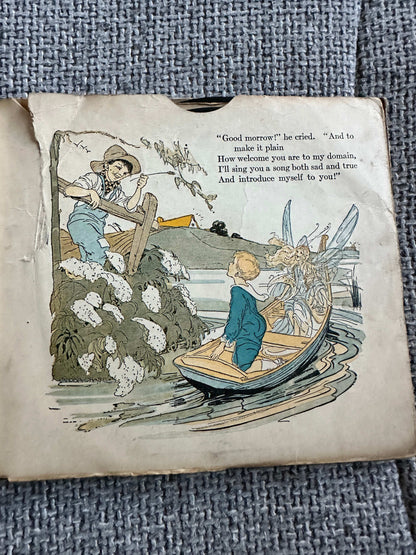 Illustration from the 1917 Happy Go Lucky Bubble Book for sale depicting a boy in a boat with a fairy