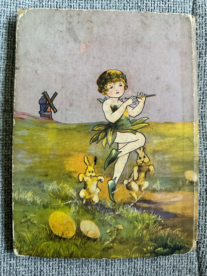 Cover of 1933 The Fairy Ring hardback featuring a girl playing a flute surrounded by rabbits