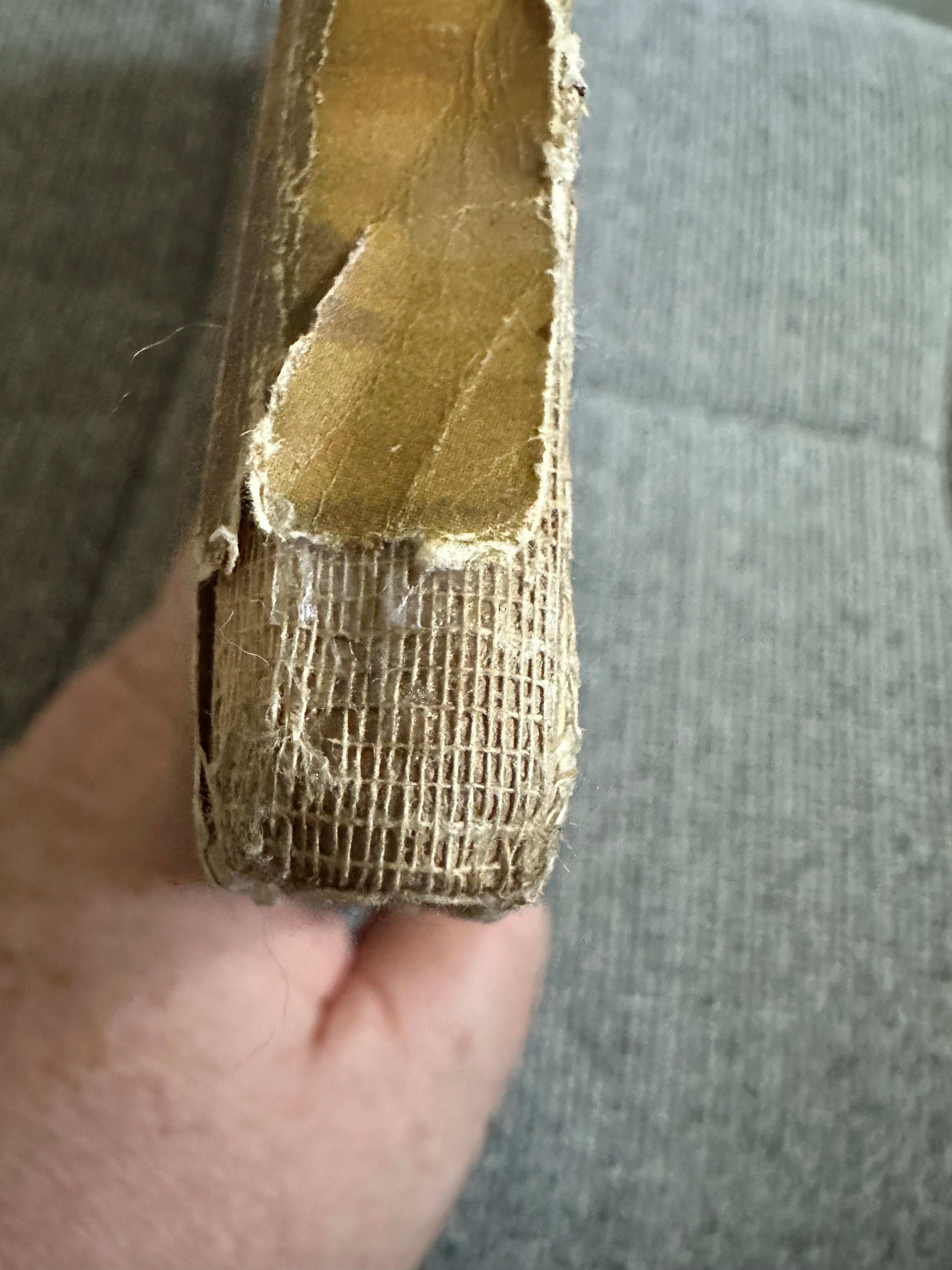 Close-up of the spine of 1933 The Fairy Ring hardback book showing worn edges and binding detail