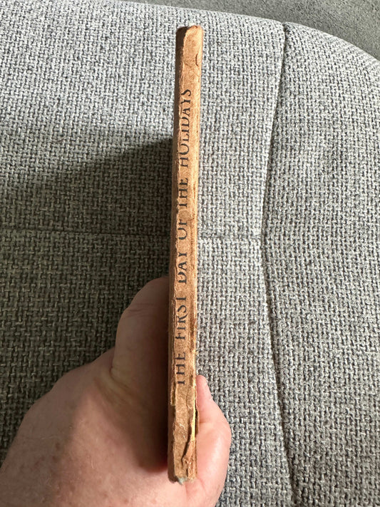 Side view of 1947 Ladybird book The First Day Of The Holidays showcasing its worn spine