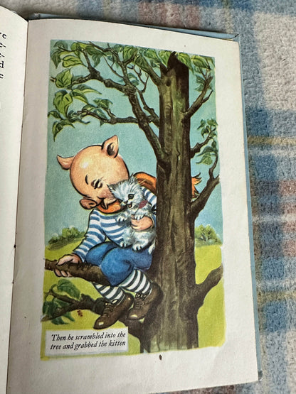 Illustration from 1959 Bobby Bear The Fireman book showing a boy in a tree with a kitten