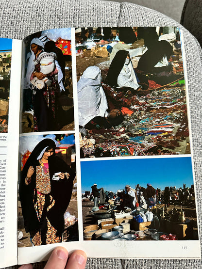 Inside pages of a 1992 Israel travel book featuring local markets and cultural scenes