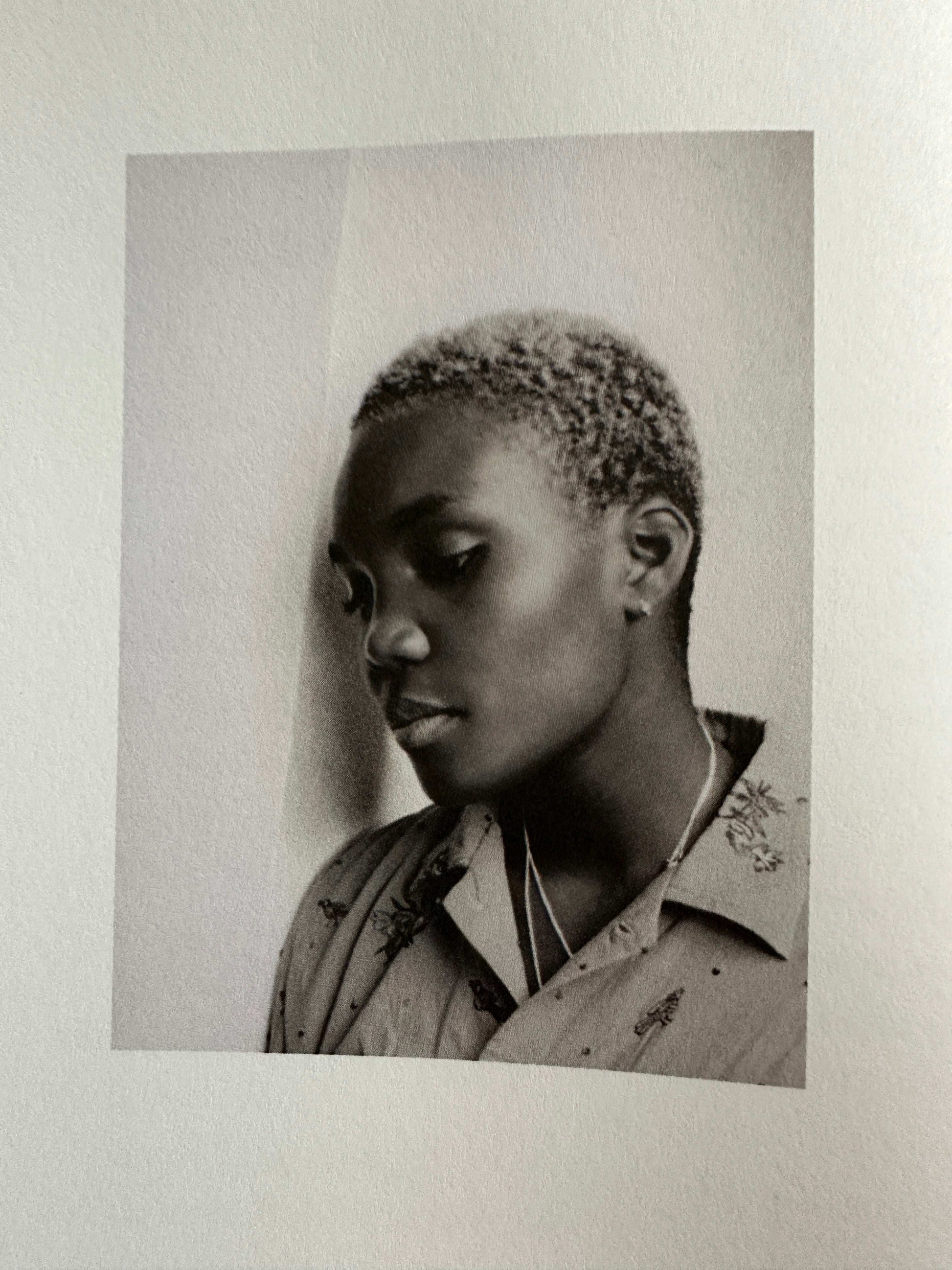 The Magic Border signed poetry book interior page featuring a thoughtful portrait of a young person