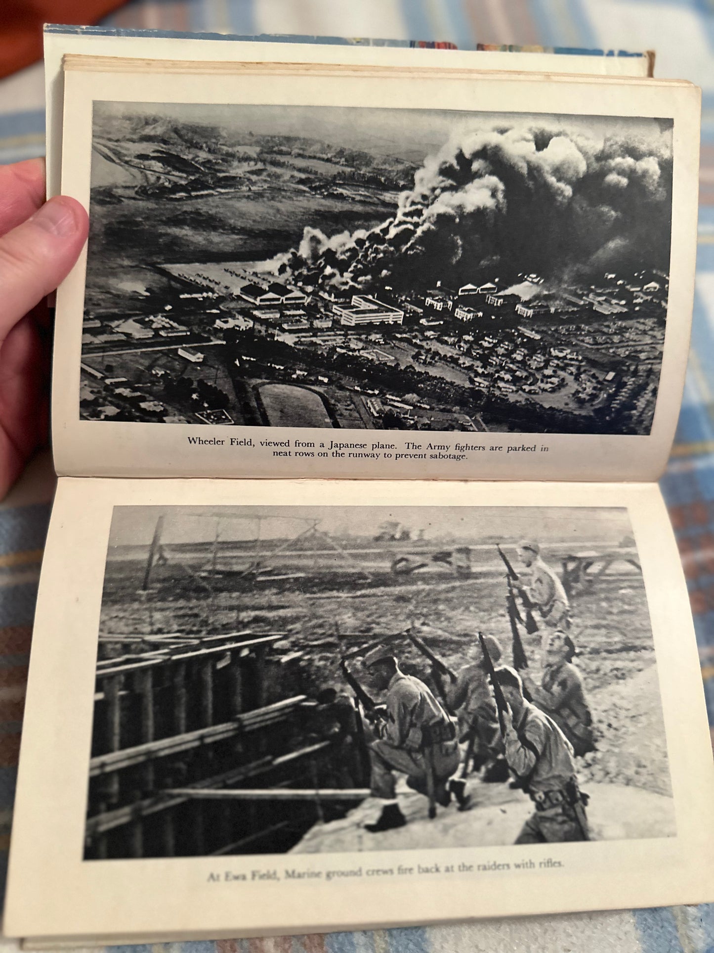 Day of Infamy first edition book opened to pages featuring historic war photographs