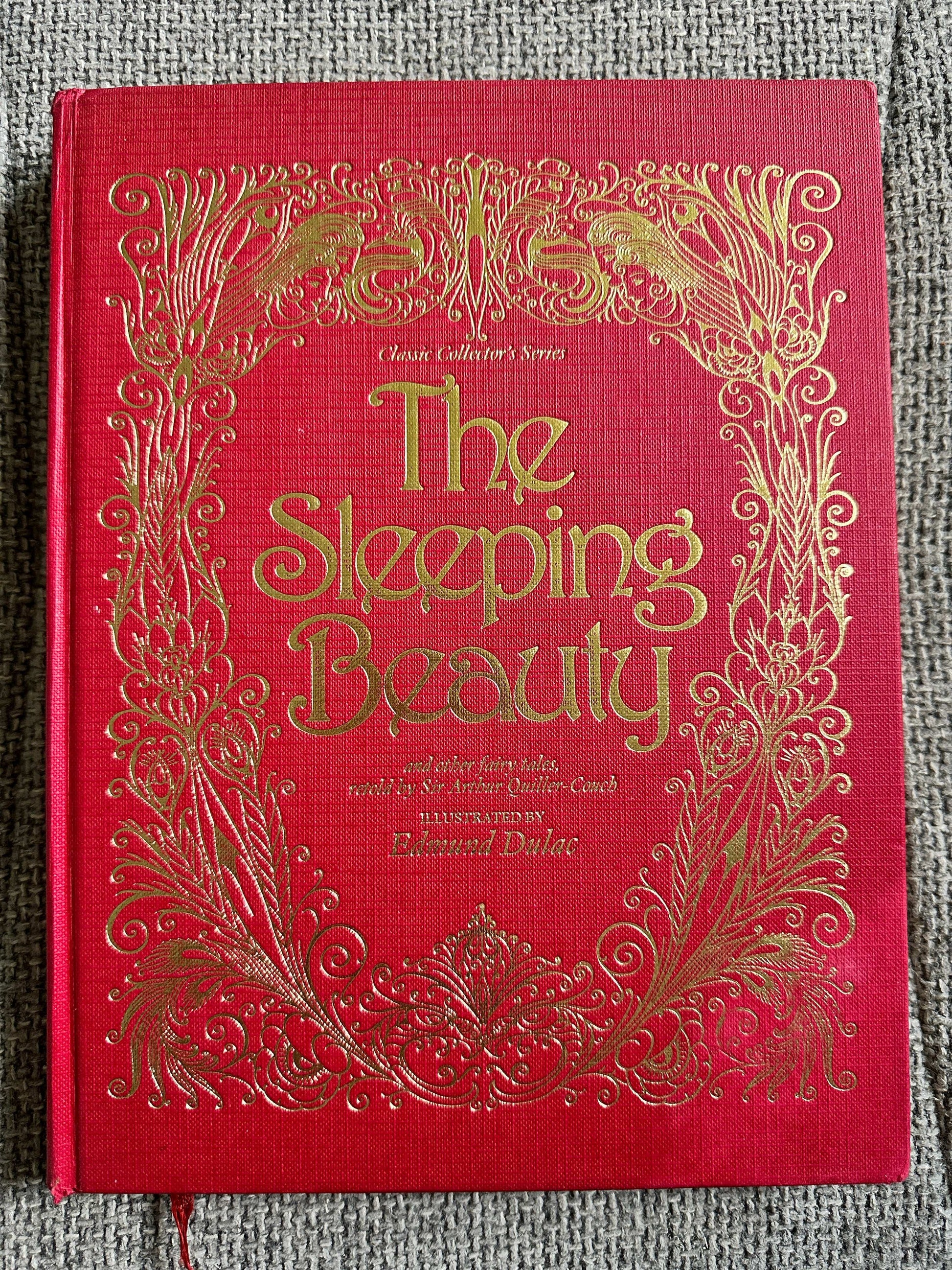 The Sleeping Beauty book featuring Edmund Dulac illustrated fairytales with ornate gold detailing on a red cover