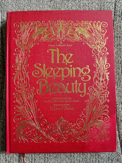 The Sleeping Beauty book featuring Edmund Dulac illustrated fairytales with ornate gold detailing on a red cover