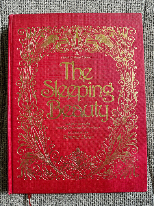 The Sleeping Beauty book featuring Edmund Dulac illustrated fairytales with ornate gold detailing on a red cover