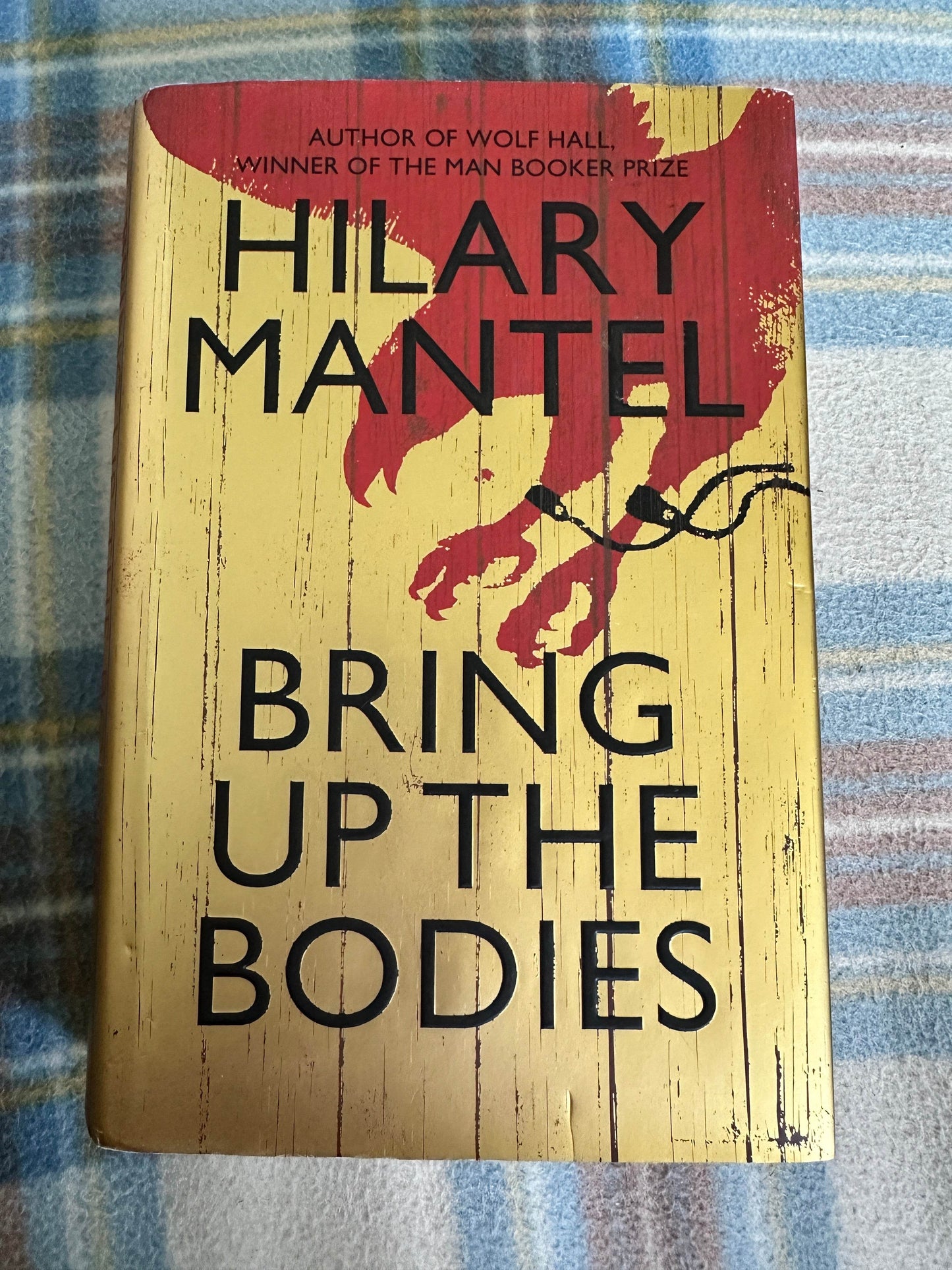 First edition Bring Up The Bodies Hilary Mantel book cover featuring striking red and yellow design