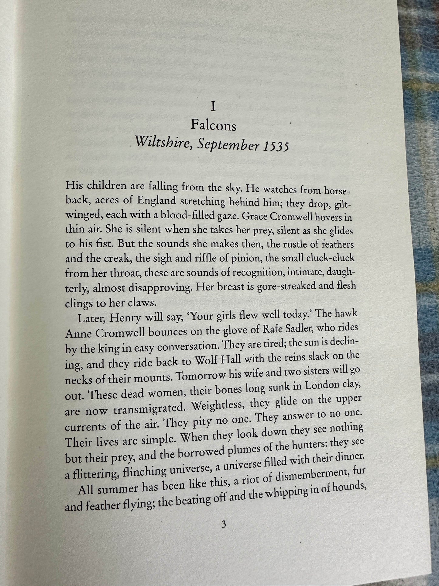 First edition Bring Up The Bodies Hilary Mantel with a page featuring talon-wearing falcons in September 1535