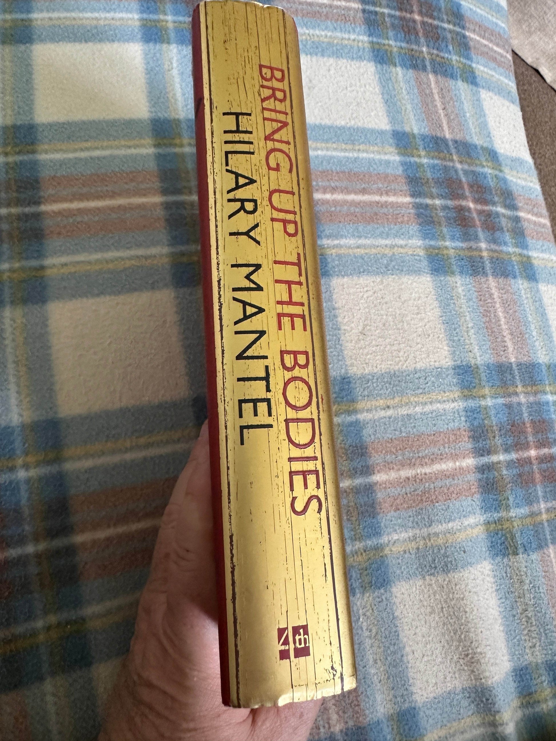 First edition Bring Up The Bodies Hilary Mantel book spine with gold lettering and textured finish