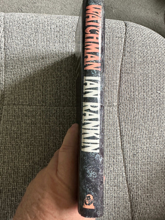 Side view of the first edition Watchman Ian Rankin showcasing the black spine and title details