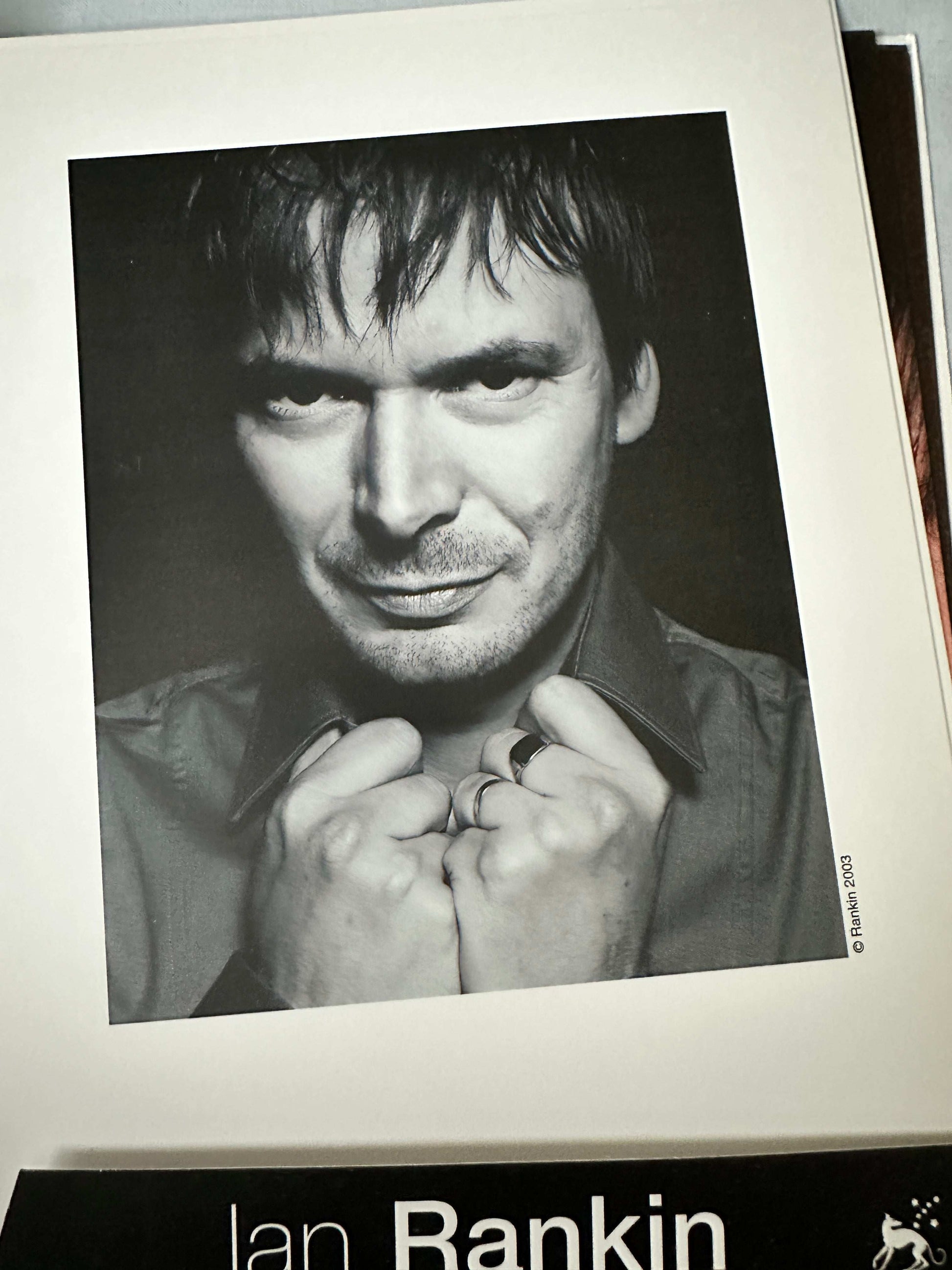 Ian Rankin signed press pack featuring a black and white portrait of the author with a thoughtful expression