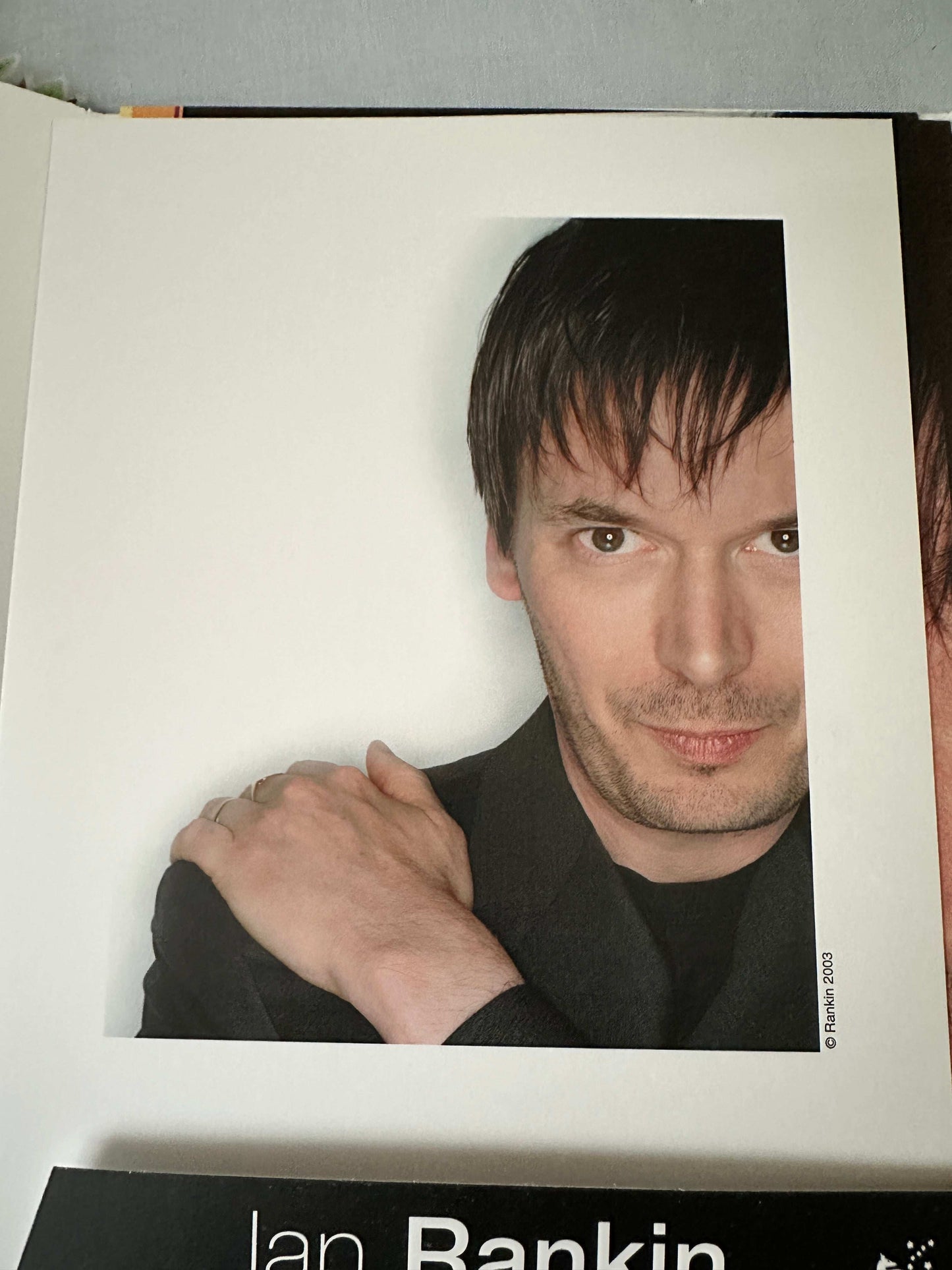 Ian Rankin signed press pack featuring an image of the author with a casual pose
