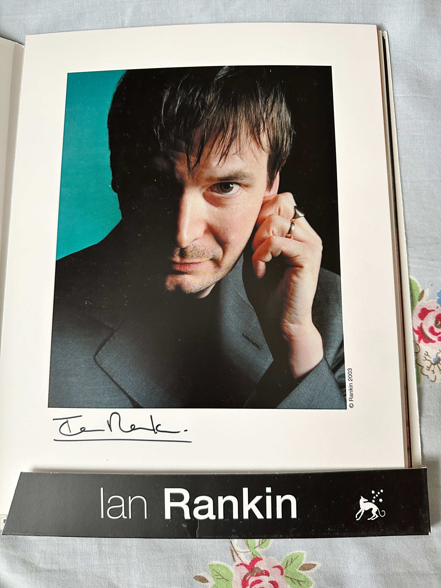 Ian Rankin signed press pack featuring a portrait of the author with his signature