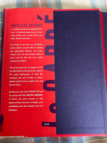 Absolute Friends first edition John le Carre book cover showcasing a striking red and black design