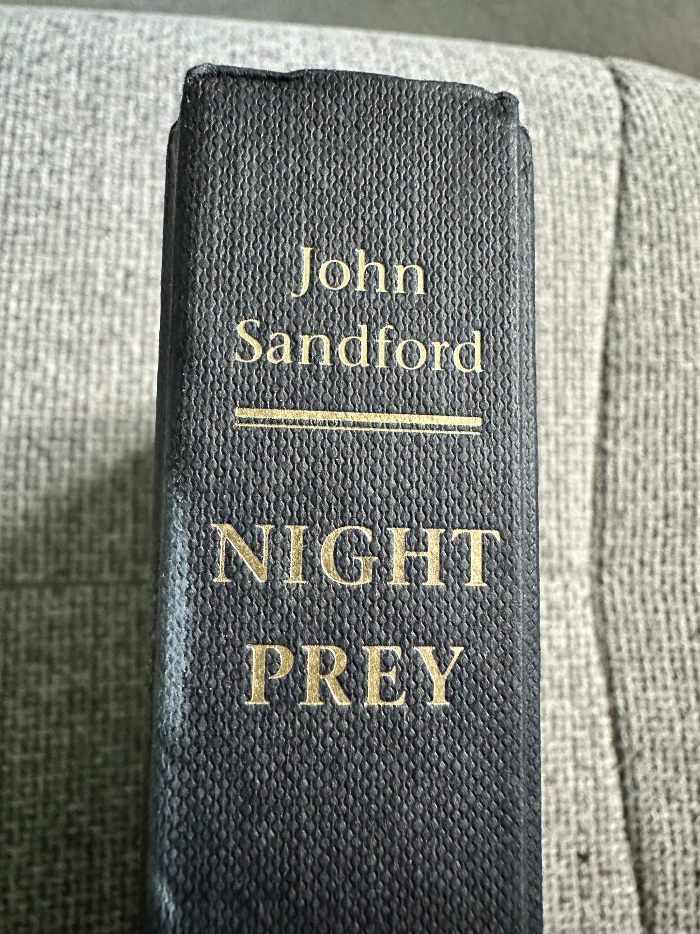 Night Prey John Sandford first edition book spine with gold lettering on a textured black cover