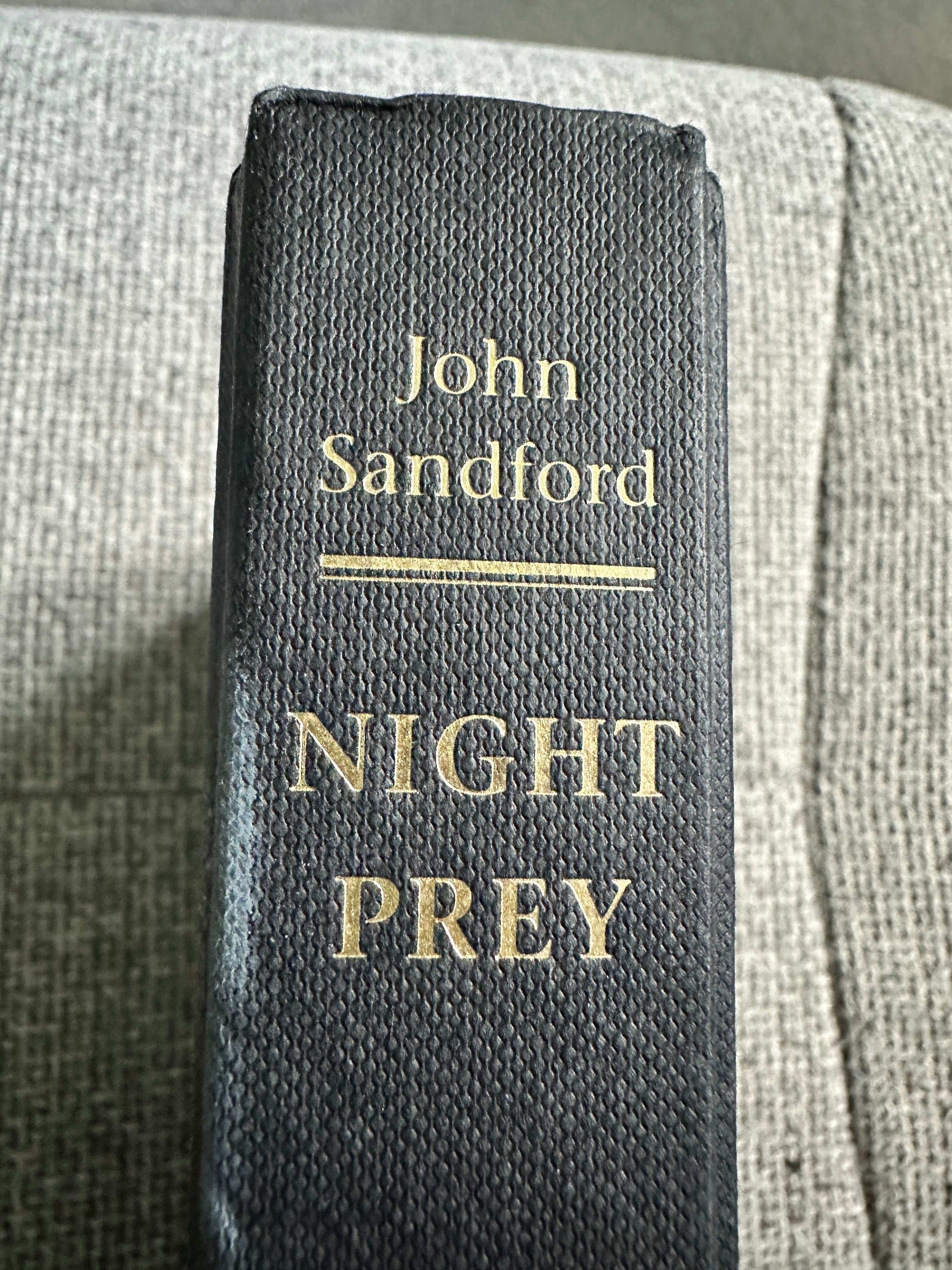 Night Prey John Sandford first edition book spine with gold lettering on a textured black cover