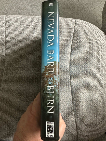 Side view of Nevada Barr Burn first edition book with a scenic cover design from Honeyburn Books