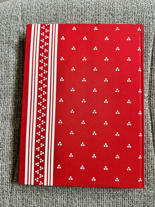Still Glides The Stream Flora Thompson hardcover book with a vibrant red cover featuring white patterns