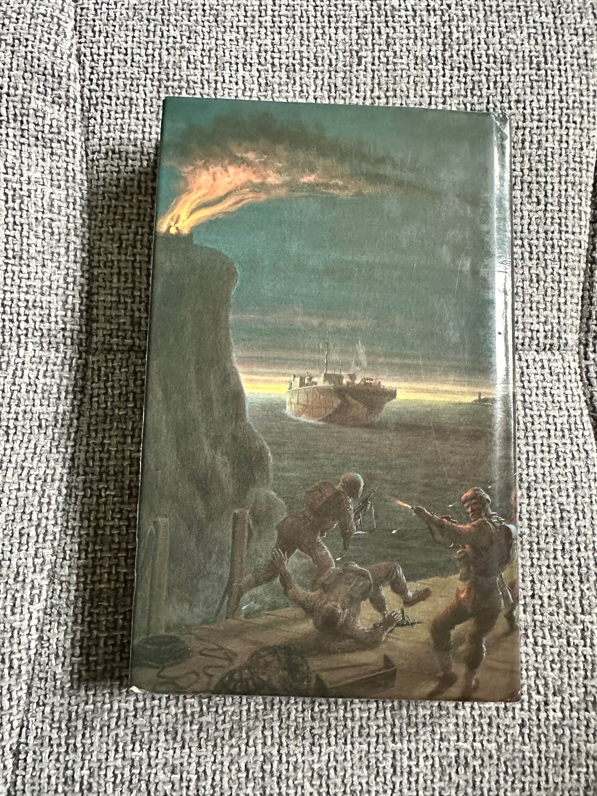 The Volunteers Douglas Reeman first edition book cover featuring a battle scene by the sea