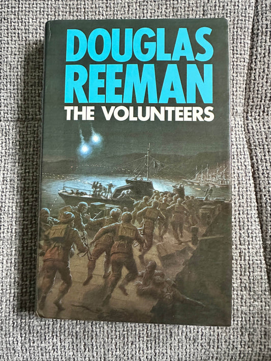 First edition of The Volunteers Douglas Reeman featuring a dramatic war scene cover design