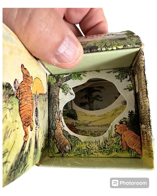 Inside view of the Winnie the Pooh Picture House book featuring illustrated characters in a scenic landscape